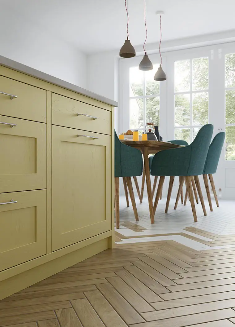 Simple inframe yellow kitchen with oak parquet flooring.