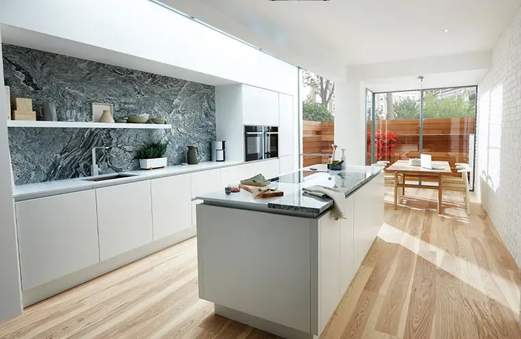 White true handleless Kitchen with aluminium rail.