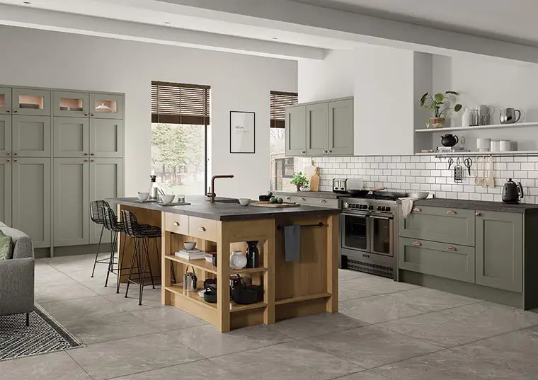 Solid wood shaker kitchen in cardamom green with light oak island and slate grey effect quartz worktop.