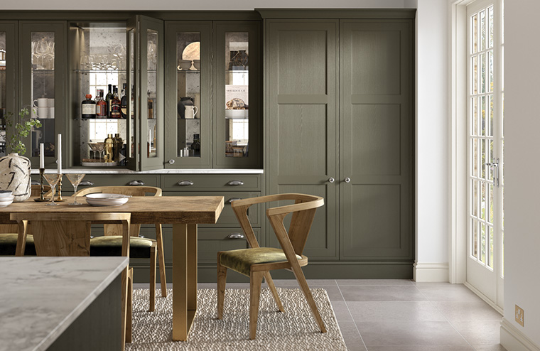 Dark green inframe shaker kitchen with glass fronted dresser units. Kitchens & Interiors, Frome, Somerset.